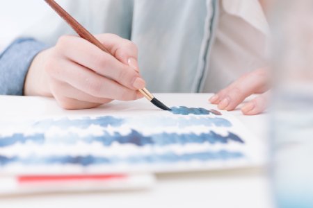 Child painting with a paintbrush